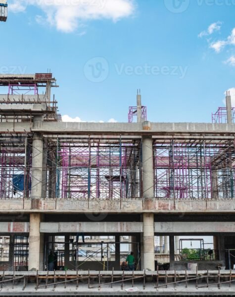 structure-of-large-building-with-worker-working-crane-and-scaffold-in-construction-site-photo